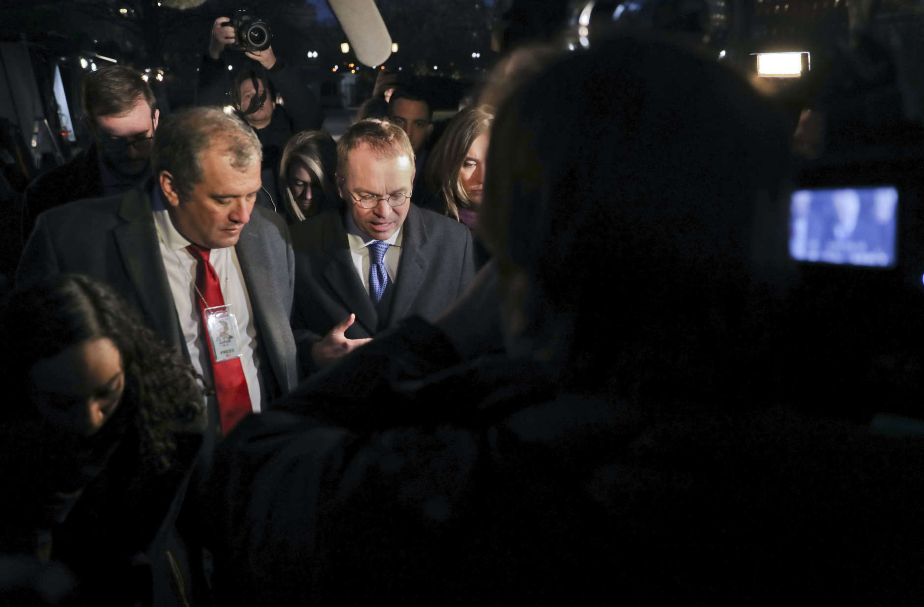 Director of the Office of Management and Budget Mick Mulvaney is surrounded by members of the media outside the White House, Friday, Jan. 19, 2018, and is questioned about a potential government shutdown this weekend. (AP Photo/Pablo Martinez Monsivais)