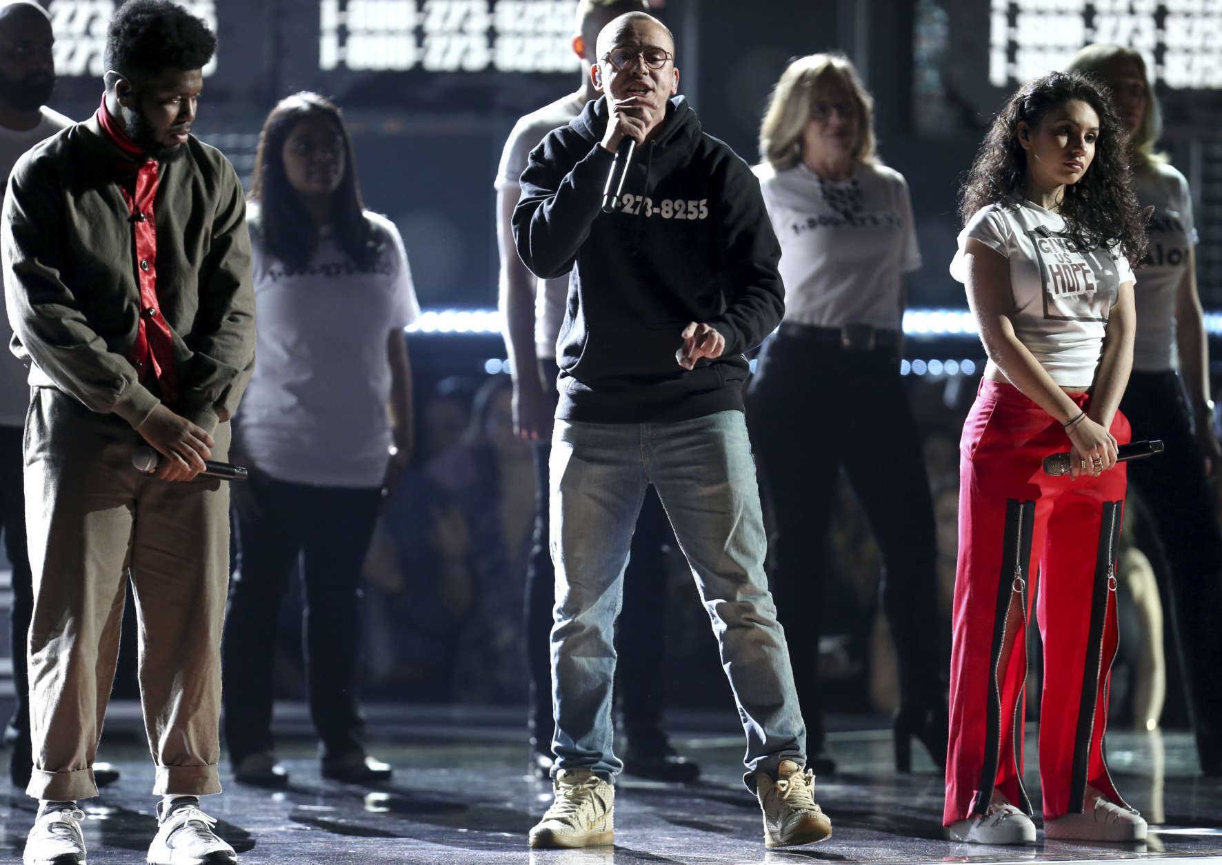 Khalid, from left, Logic, and Alessia Cara perform "1-800-273-8255" as they are accompanied on stage with individuals affected by suicide at the 60th annual Grammy Awards at Madison Square Garden on Sunday, Jan. 28, 2018, in New York. (Photo by Matt Sayles/Invision/AP)
