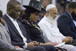 Rep. Frederica Wilson, D-Fla., center, is joined by Miami-Dade County Commissioner Jean Monestime, left, and businessman Abdul Razzak Khanani, right, during a prayer vigil before watching President Donald Trump's State of the Union at a watch party held at the Historic Greater Bethel AME Church, Tuesday, Jan. 30, 2018, in Miami. (AP Photo/Wilfredo Lee)