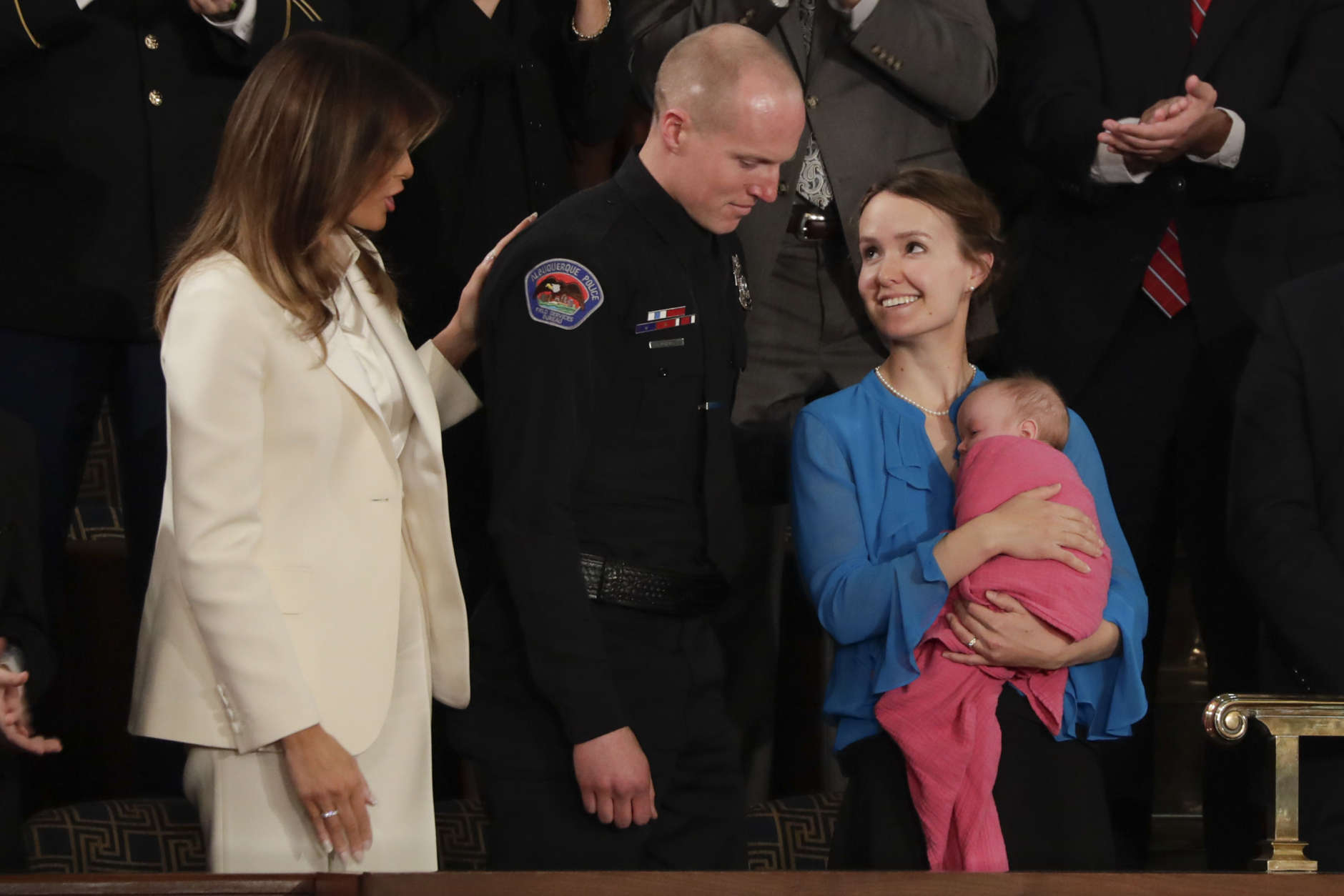 Rebecca Holets looks up at her husband Albuquerque Police Officer Ryan Holets after their introduction by President Donald Trump as they stand with first lady Melania Trump during the State of the Union address to a joint session of Congress on Capitol Hill in Washington, Tuesday, Jan. 30, 2018. (AP Photo/J. Scott Applewhite)
