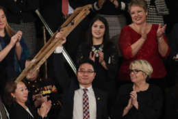 Ji Seong-ho holds up his crutches after his introduction by President Trump during the State of the Union address to a joint session of Congress on Capitol Hill in Washington, Tuesday, Jan. 30, 2018. (AP Photo/J. Scott Applewhite)