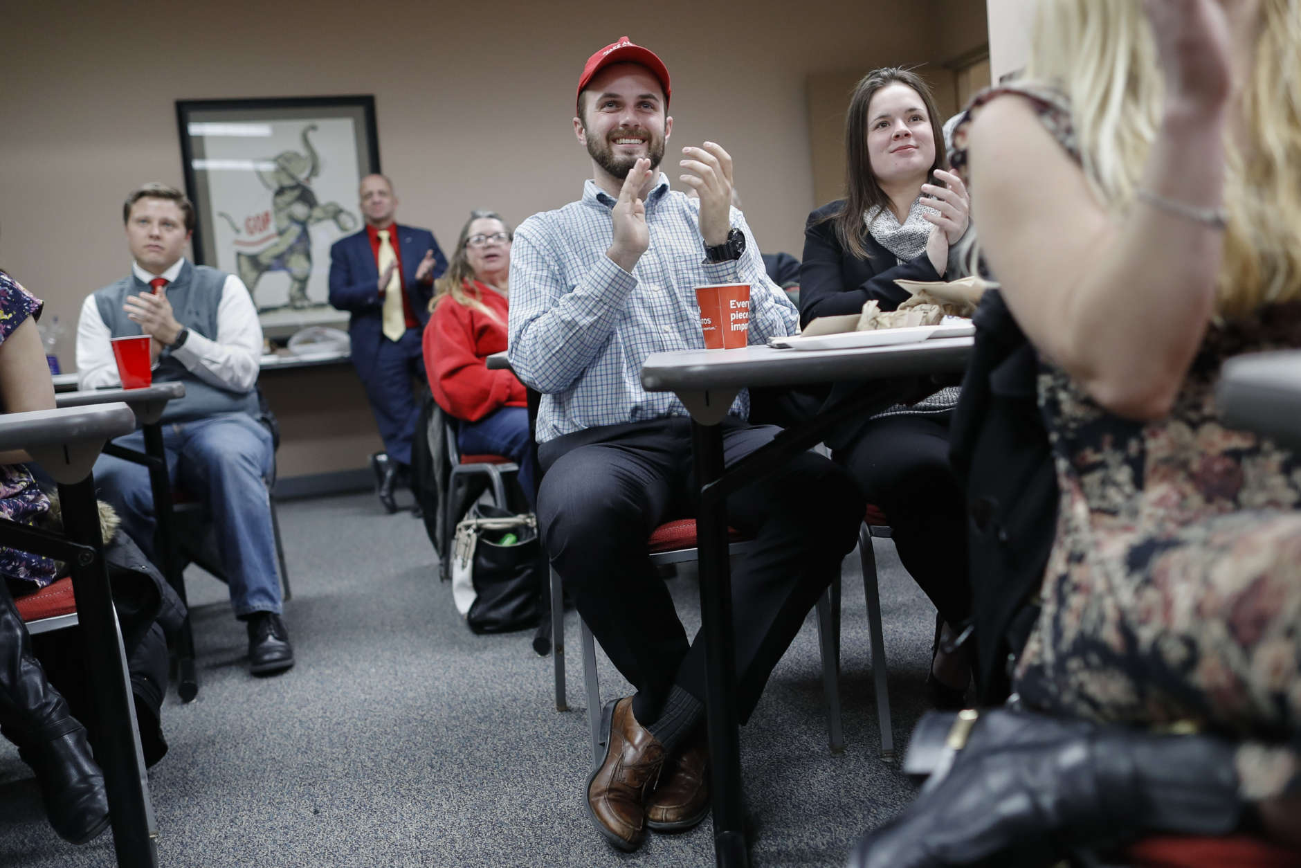 Supporters applaud as they watch President Donald Trump speak at a State of the Union watch party hosted by the Hamilton County Republican Party, Tuesday, Jan. 30, 2018, in Cincinnati. (AP Photo/John Minchillo)