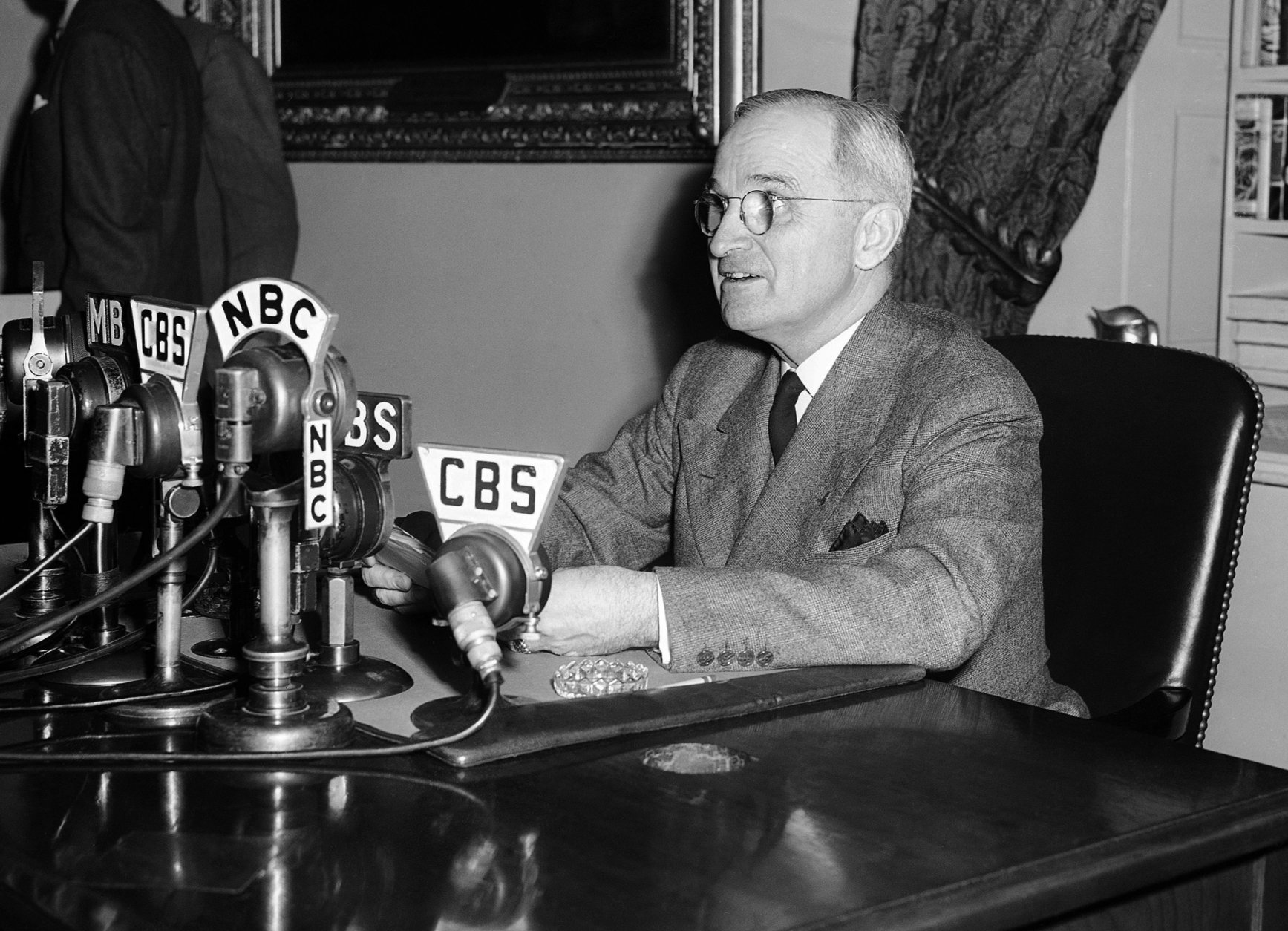 FILE - In this April 25, 1945, file photo, U.S. President Harry S. Truman speaks from a desk in Washington.  (AP Photo/File)