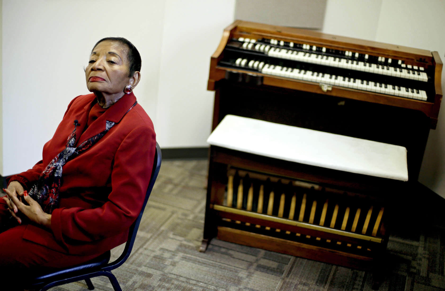 In this Wednesday, Nov. 14, 2012 photo, Christine King Farris, the sister to Rev. Martin Luther King Jr., and daughter of Martin Luther King Sr., sits next to the organ played by her mother, Alberta Christine Williams King, at which she was fatally shot while playing during a church service in 1974, as the organ sits on display in the new Martin Luther King, Sr. Community Resources Complex in Atlanta. The new Atlanta community center intended to help low-income residents become more financially secure has been envisioned as a living legacy for the Rev. Martin Luther King Sr., father of the civil rights icon. (AP Photo/David Goldman)