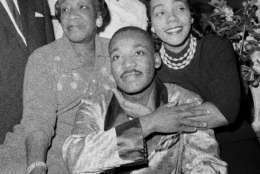 Dr. Martin Luther King, Jr., is embraced by his wife Coretta Scott King during a news conference at Harlem Hospital in New York, Sept 30, 1958, where he is recovering from a stab wound following an attack by a woman.  At left is his mother, Alberta Williams King.  (AP Photo/Tony Camerano)