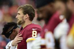LANDOVER, MD - DECEMBER 24: Quarterback Kirk Cousins #8 of the Washington Redskins listens to the National Anthem before a game against the Denver Broncos at FedExField on December 24, 2017 in Landover, Maryland. (Photo by Patrick McDermott/Getty Images)