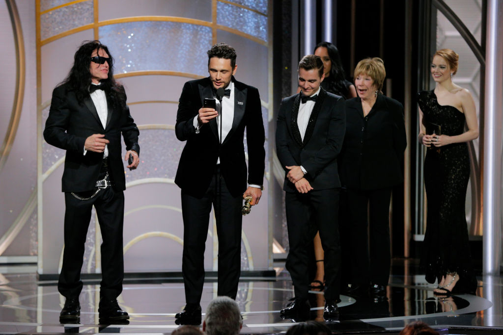 BEVERLY HILLS, CA - JANUARY 07: In this handout photo provided by NBCUniversal, James Franco, with Tommy Wiseau and Dave Franco, accepts the award for Best Performance by an Actor in a Motion Picture – Musical or Comedy for “The Disaster Artist” during the 75th Annual Golden Globe Awards at The Beverly Hilton Hotel on January 7, 2018 in Beverly Hills, California. (Photo by Paul Drinkwater/NBCUniversal via Getty Images)