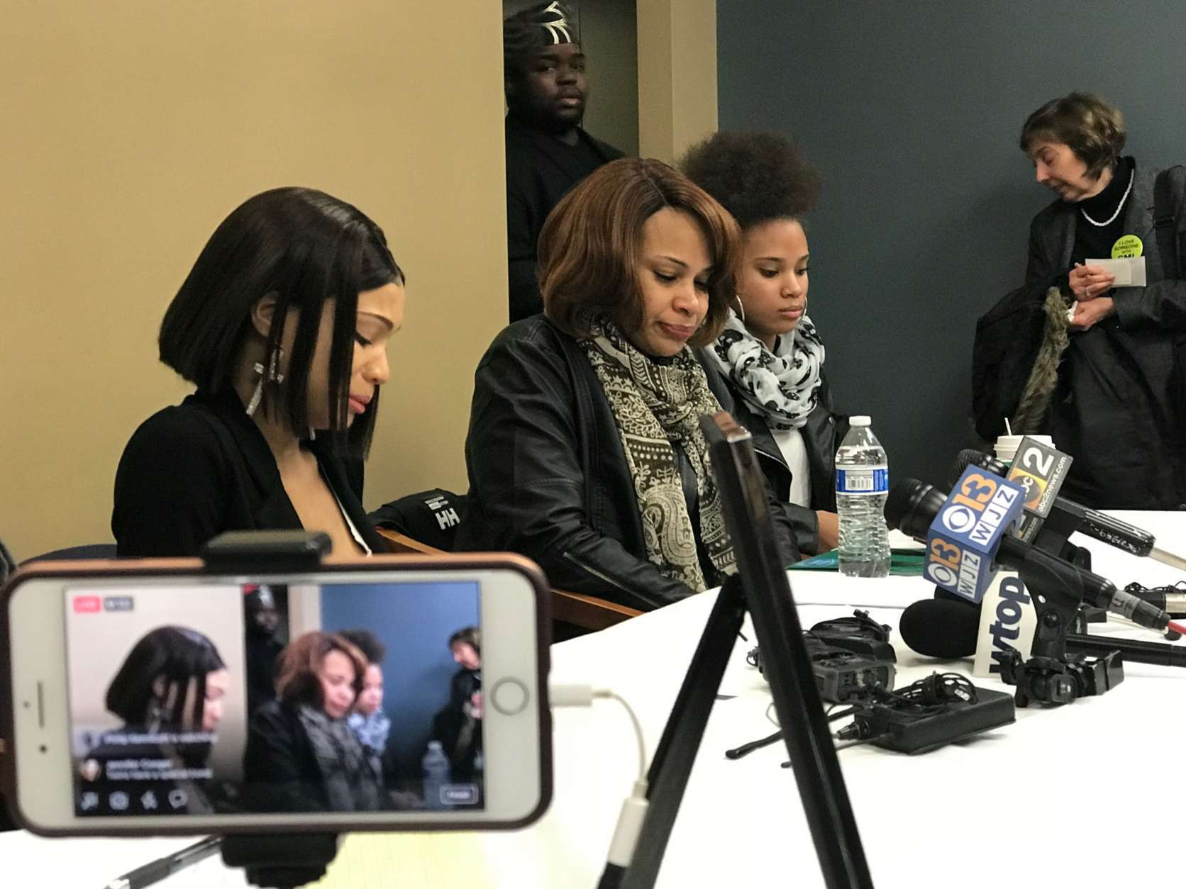 The patient's twin sister, mother and younger sister, left to right, sit at a press conference to discuss their side of the story in attorney J. Wendal Gordon's Baltimore, Maryland office. (WTOP/Megan Cloherty)