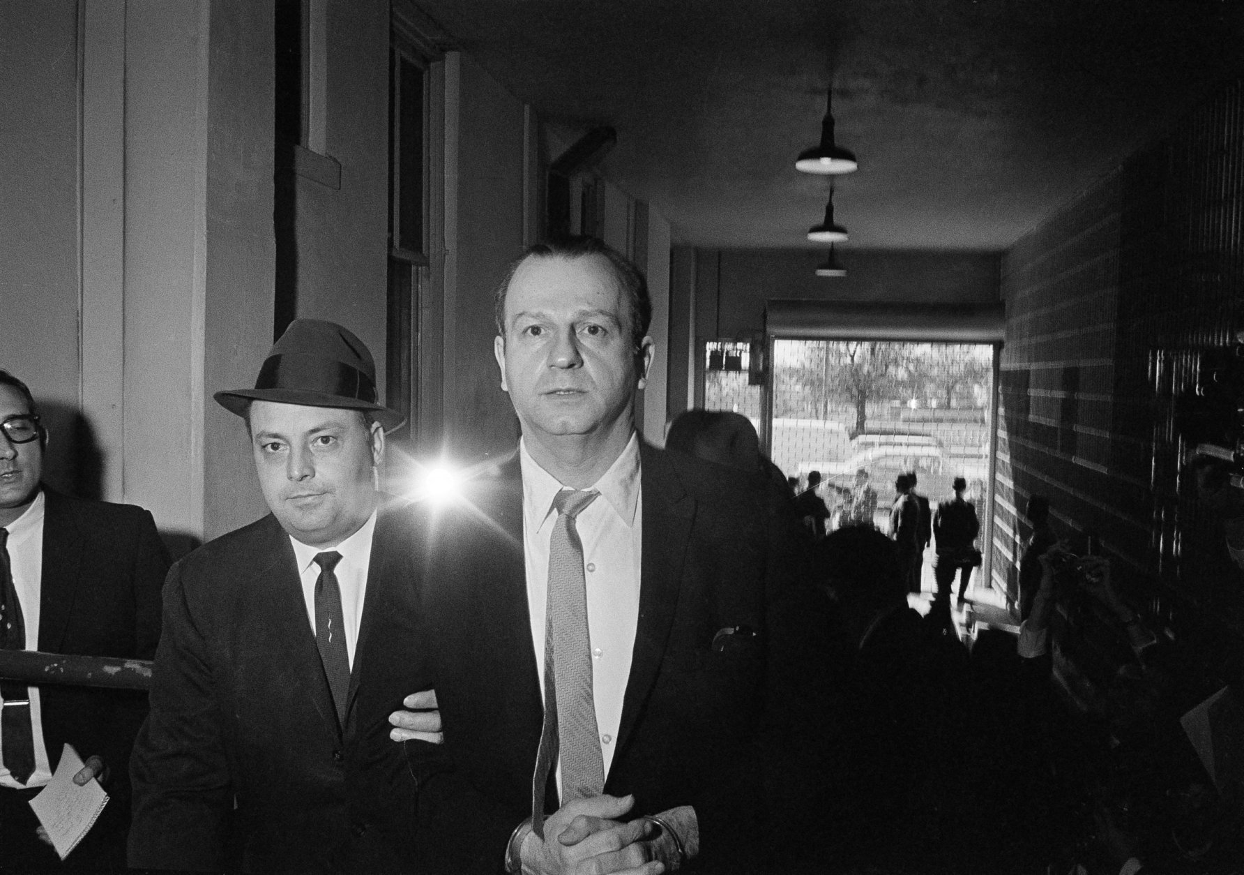 Jack Ruby, who shot and killed Lee Harvey Oswald, is shown being returned to jail after a psychiatric examination in Dallas, Tex., Jan. 28, 1964.  (AP Photo/Ferd Kaufman)