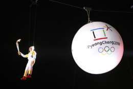 South Korean Ryu Seung-min, a member of the IOC Athletes Commission, carries the Olympic torch as he hangs from a wire during the Olympic Torch Relay in Incheon, South Korea, Wednesday, Nov. 1, 2017. The Olympic flame arrived in South Korea Wednesday where it will be passed throughout the country by thousands of torchbearers on a 100-day journey to the opening ceremony of the 2018 Winter Olympics in Pyeongchang. (AP Photo/Lee Jin-man)