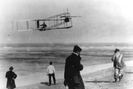 In this undated file photo, Orville and Wilbur Wright test their airplane on a beach. The Wright brothers have long been credited as the first to achieve powered flight. But in June, 2013, Connecticut Gov. Dannel P. Malloy signed a law giving German-born aviator and Connecticut resident Gustave Whitehead the honor of being first. On Thursday, Oct. 23, 1013 Ohio state Rep. Rick Perales and North Carolina state Sen. Bill Cook held news conferences to dispute Connecticut's action and reassert the Wright Brothers were first in flight. (AP Photo/File)