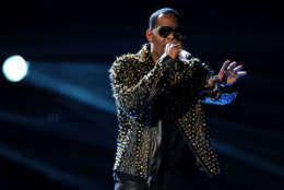 FILE - In this June 30, 2013 file photo, R. Kelly performs onstage at the BET Awards at the Nokia Theatre  in Los Angeles. The owners of 5001 Flavors knew when they started the company 23 years ago they wanted to sell custom-made clothes to rap and R&amp;B musicians. They sought out artists and record company executives at parties and music industry events. They looked in particular for up-and-coming artists. Now musicians like R. Kelly and Kid Rock are among their fans. (Photo by Frank Micelotta/Invision/AP)