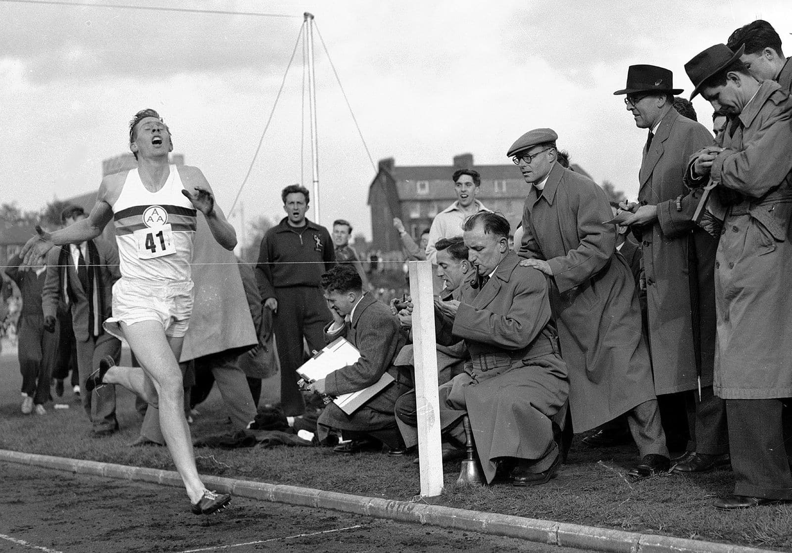 FILE - In this May 6, 1954 file photo, Britain's Roger Bannister hits the tape to become the first person to break the four-minute mile in Oxford, England. A statement released Sunday March 4, 2018, on behalf of Bannister's family said Sir Roger Bannister died peacefully in Oxford on March 3, aged 88. (AP Photo, File)