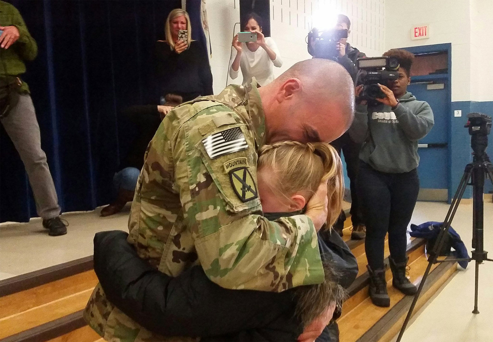 Brent Mount hugs his daughter Katie after surprising her during a school assembly Monday morning at Park Ridge Elementary in Stafford County. Mount has spent the last six months deployed to Afghanistan. (WTOP/Kathy Stewart)