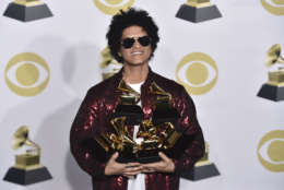 Bruno Mars poses in the press room with his awards for best R&amp;B album, record of the year, album of the year, best engineered album, non-classical, for "24K Magic," and song of the year, best R&amp;B performance and best R&amp;B song, for "That's What I Like" at the 60th annual Grammy Awards at Madison Square Garden on Sunday, Jan. 28, 2018, in New York. (Photo by Charles Sykes/Invision/AP)