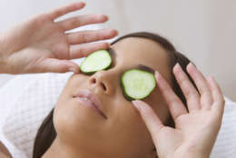 Young woman resting with cucumbers on her eyes