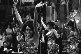 FILE -In this Jan. 21, 1968 file photo, The Supremes with Diana Ross, front, Cindy Birdsong and Mary Wilson dance with their arms in the air as they perform at the annual "Bal pare" party in Munich, West Germany. Ross, Wilson and the Florence Ballard made up the first successful configuration of the group. Cindy Birdsong replaced Ballard in 1967. Wilson, now 70, reminisced in an interview with Associated Press on June 12, 2014, about a major milestone: the 50th anniversary of the Supremes first No. 1, million-selling song, “Where Did Our Love Go” - released June 17, 1964.  (AP Photo/Klaus Frings, file)
