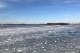 The layers of ice almost resemble waves hitting a shoreline, where the Anacostia and Potomac Rivers meet the Washington Channel. On the left is Arlington, Virginia and on the right Washington, DC. (WTOP/Megan Cloherty)