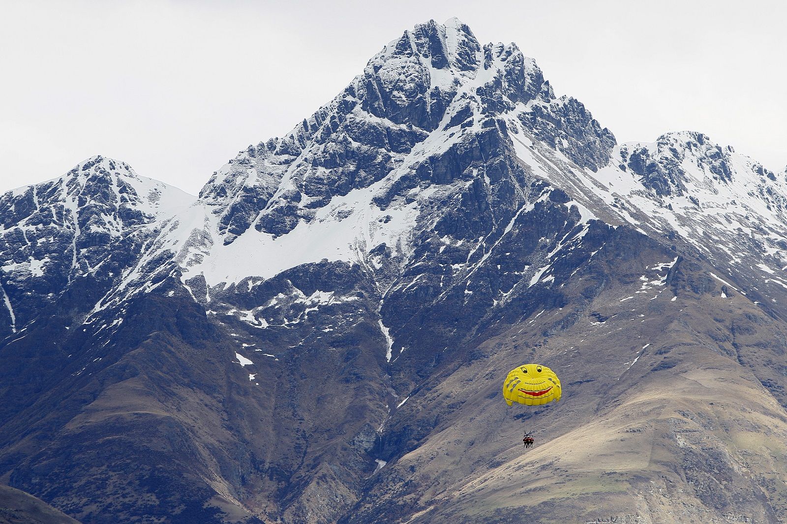 A group of tourists parasail over Lake Wakatipu with the backdrop of the Remarkables mountain range in Queenstown, New Zealand, Thursday, Sept., 15, 2011. (AP Photo/Alastair Grant)