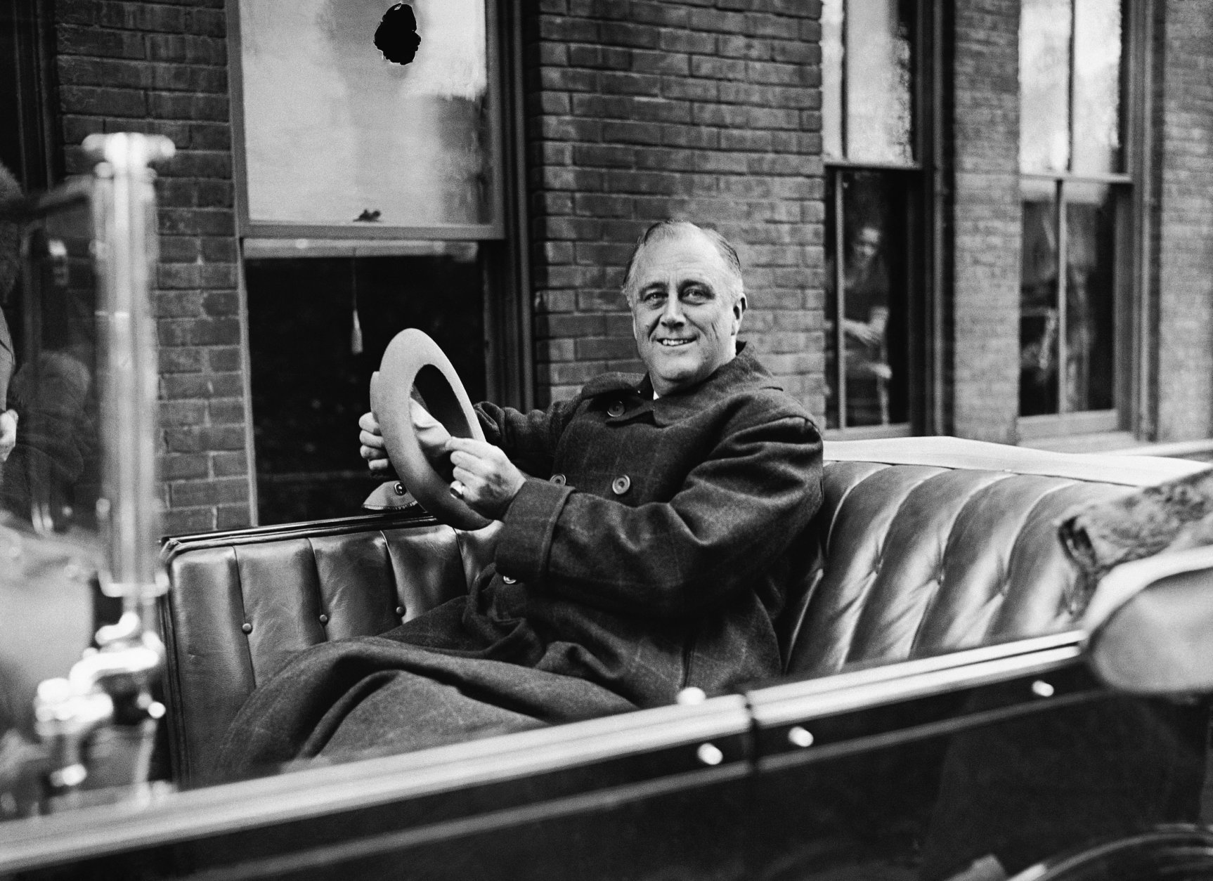 ** FILE ** In this Oct. 29, 1932 file photo, Gov. Franklin D. Roosevelt of New York is shown in his car in Albany as he starts out for his campaign speaking tour.   The "mirage" of American economic invulnerability has vanished, along with "much of the savings of thrifty and prudent men and women," the presidential hopeful told the crowd. Franklin Roosevelt's words in 1932 are oddly prescient for today's crisis. (AP Photo)