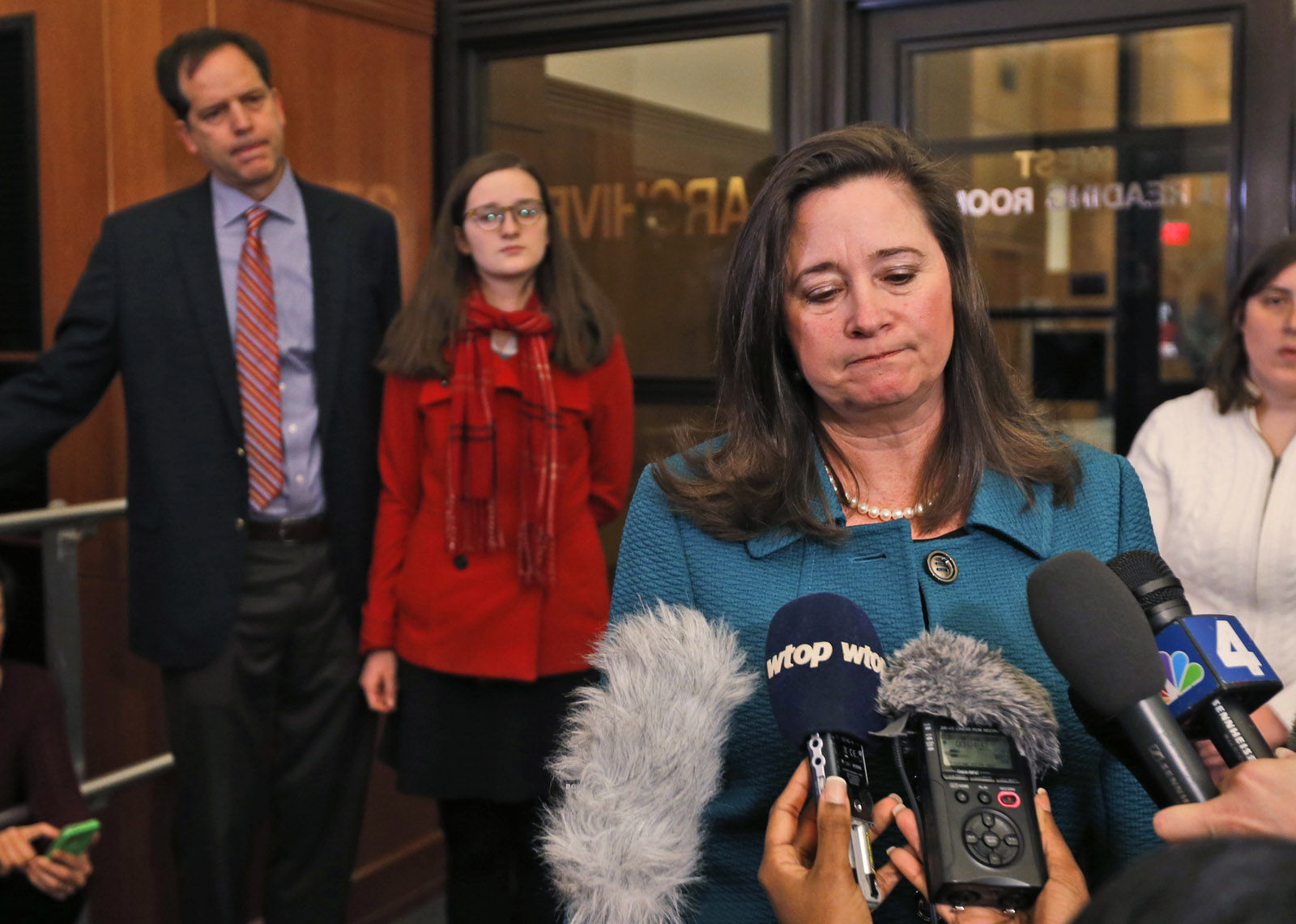 Democratic candidate for the 94th House of Delegates seat, Shelly Simonds, right, speaks to the media as her husband, Paul Danehy, left, and daughter, Georgia Danehy, center, look on after a drawing to determine the winner of a tied election at the Capitol in Richmond, Va., Thursday, Jan. 4, 2018. Republican Delegate David Yancey won the drawing. (AP Photo/Steve Helber)