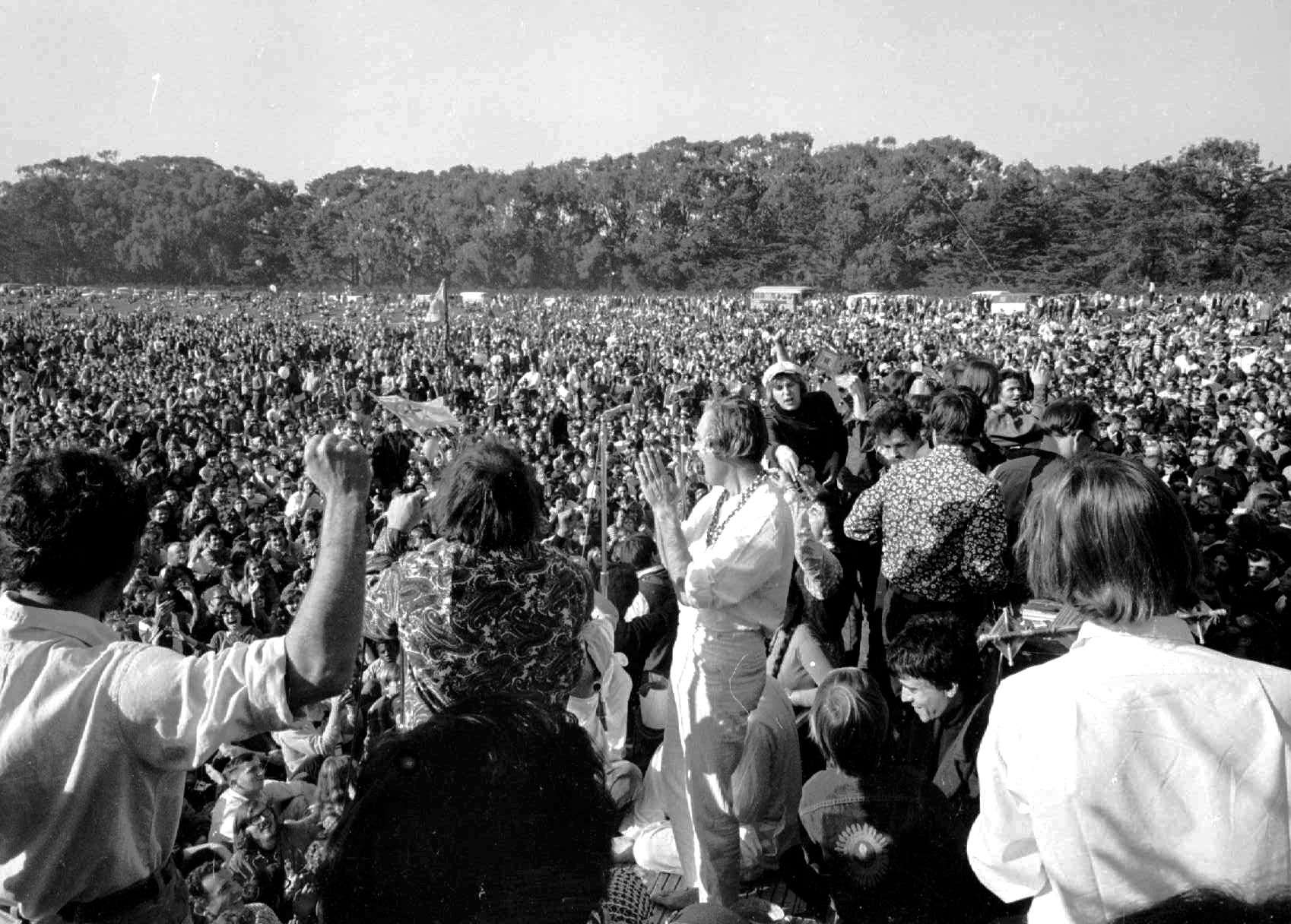 FILE - In this Jan. 15, 1967 file photo, Timothy Leary, center, leads thousands in a song at the "Human Be-In" on the Golden Gate Park Polo Fields in San Francisco. Dennis McNally, who has curated an exhibit at the California Historical Society, says the national media paid little attention to San Francisco's psychedelic community until January 1967, when poets and bands joined forces for the “Human Be-In,” which unexpectedly drew about 50,000 people. Leary stood on stage and delivered his famous mantra: “Turn on. Tune In. Drop out.” (AP Photo)