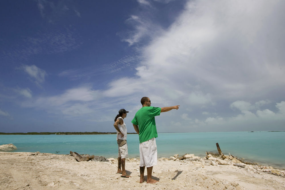 Residents who are originally from New Jersey watch the first bands of Hurricane Ike approach to the east of the Island of Providenciales on Turks &amp; Caicos Islands, Saturday, Sept. 6, 2008.  Ike is due to arrive to the Turks and Caicos as a Category 3 hurricane. (AP Photo/Brennan Linsley)