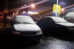 Snow coats some parked cars in Germantown. (WTOP/Kathy Stewart)