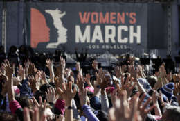 People hold their hands up at a Women's March against sexual violence and the policies of the Trump administration Saturday, Jan. 20, 2018, in Los Angeles. (AP Photo/Jae C. Hong)