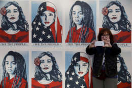 A protester takes a selfie in front of posters supporting women's rights during a Women's March, Saturday, Jan. 20, 2018, in Los Angeles. (AP Photo/Jae C. Hong)