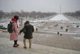 Visitors are careful not to slip as they begin to make their way down the stairs after visiting the Lincoln Memorial on the National Mall in Washington, Thursday, Jan. 4, 2018. (AP Photo/Pablo Martinez Monsivais)