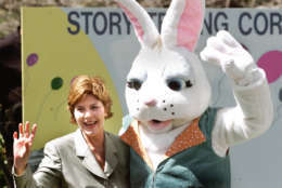 First lady Laura Bush waves with the Easter Bunny at the annual White House Easter Egg Roll, Monday, April 1, 2002, in Washington.  10,800 eggs were boiled, the president's dog was captured in a chocolate sculpture and the White House opened the gates to hundreds of children for the annual egg roll on the South Lawn.     (AP Photo/Ron Edmonds)
