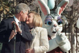 As the Easter Bunny applauds at right, President Clinton huddles with first lady Hillary Rodham Clinton at the White House, Monday, April 8, 1996, during the annual White House Easter Egg Roll and Hunt. (AP Photo/Dennis Cook)
