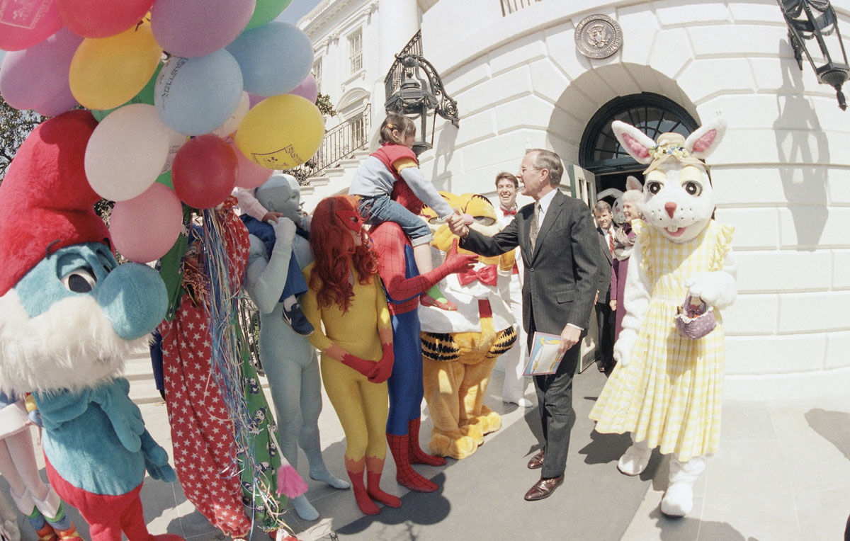 U.S. Vice President George H. Bush greeted by cartoon characters at the start of the annual Easter egg roll on the White House, April 8, 1985 in Washington. (AP Photo)