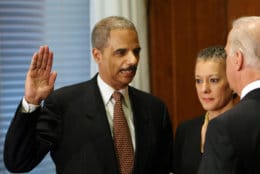 ** RETRANSMISSION FOR ALTERNATE CROP ** Vice President Joseph Biden administers the oath of office to Attorney General Eric Holder during a ceremony at the Justice Department in Washington, Tuesday, Feb. 3, 2009. Holder's wife Sharon Malone is at center. (AP Photo/Gerald Herbert)