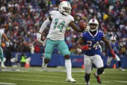 Miami Dolphins' Jarvis Landry (14) makes a one-handed catch in front of Buffalo Bills' Leonard Johnson (24) during the second half of an NFL football game Sunday, Dec. 17, 2017, in Orchard Park, N.Y. (AP Photo/Rich Barnes)