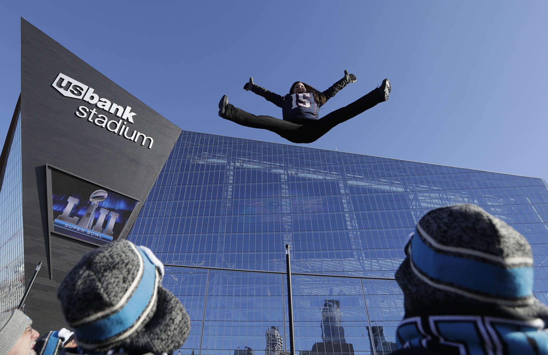 A fan jumps on a trampoline outside U.S. Bank Stadium before the NFL Super Bowl 52 football game between the Philadelphia Eagles and the New England Patriots Sunday, Feb. 4, 2018, in Minneapolis. (AP Photo/Eric Gay)