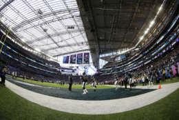 In this photo taken with a fisheye lens, Philadelphia Eagles players warm up before the NFL Super Bowl 52 football game against the New England Patriots, Sunday, Feb. 4, 2018, in Minneapolis. (AP Photo/Frank Franklin II)
