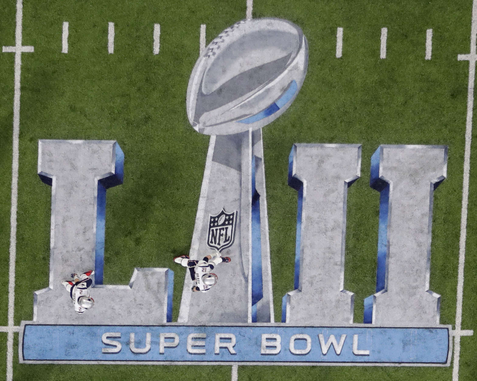 New England Patriots quarterback Tom Brady (12) walks across the NFL Super Bowl 52 logo before the football game against the Philadelphia Eagles, Sunday, Feb. 4, 2018, in Minneapolis. (AP Photo/Eric Gay)