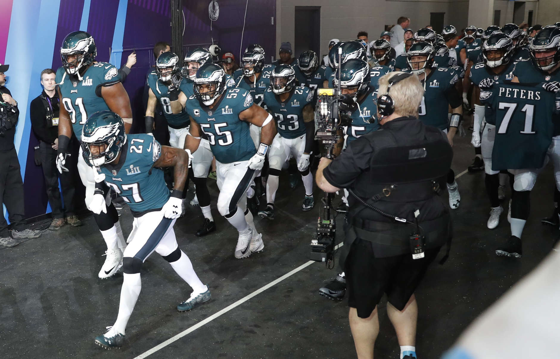 Philadelphia Eagles players run to the field as they are introduced before the NFL Super Bowl 52 football game against the New England Patriots, Sunday, Feb. 4, 2018, in Minneapolis. (AP Photo/Charlie Neibergall)