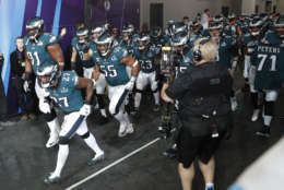Philadelphia Eagles players run to the field as they are introduced before the NFL Super Bowl 52 football game against the New England Patriots, Sunday, Feb. 4, 2018, in Minneapolis. (AP Photo/Charlie Neibergall)