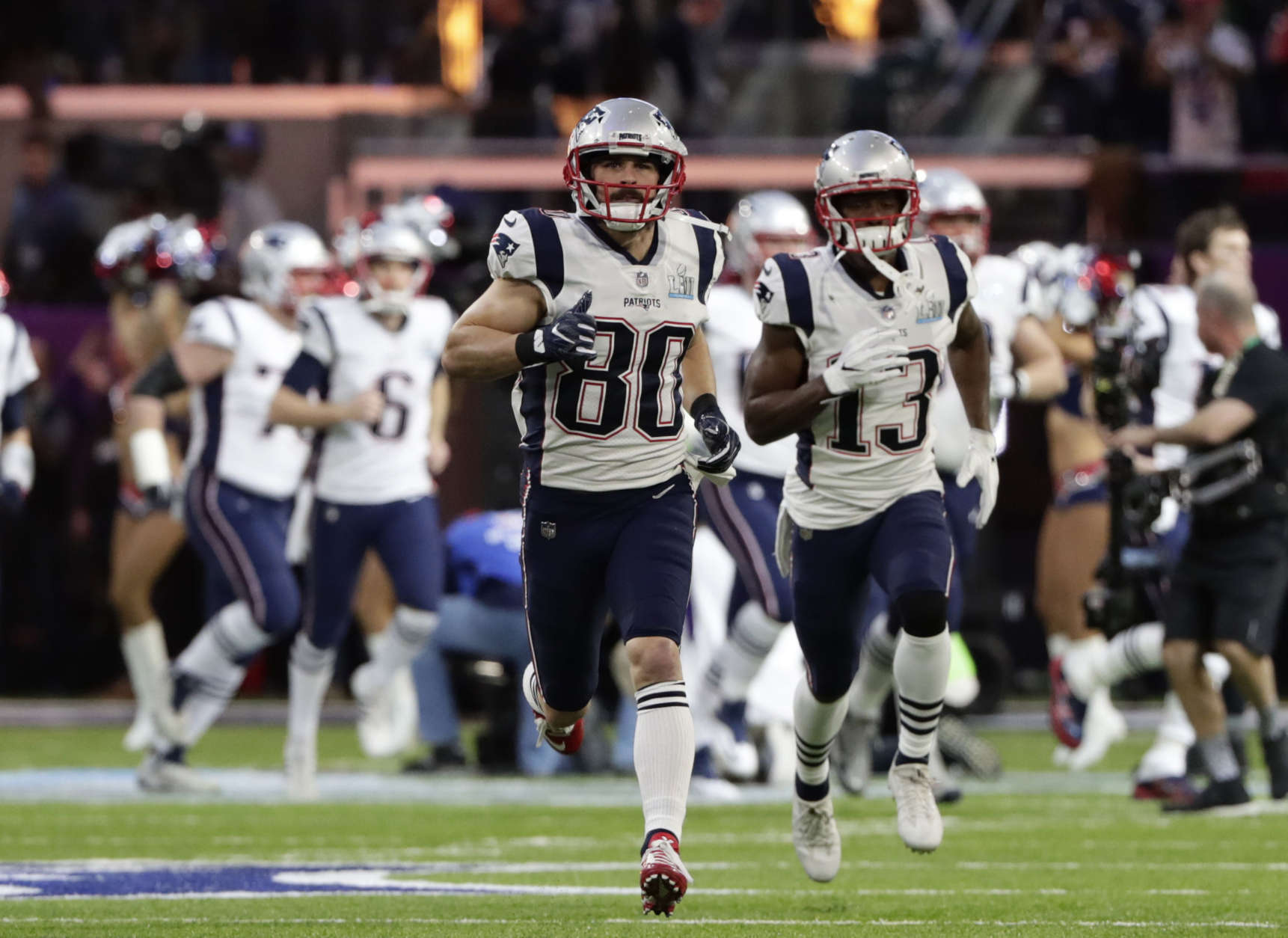 New England Patriots wide receiver Danny Amendola (80), wide receiver Phillip Dorsett (13) and the rest of the team, run on the field as they are introduced before the NFL Super Bowl 52 football game against the Philadelphia Eagles, Sunday, Feb. 4, 2018, in Minneapolis. (AP Photo/Frank Franklin II)