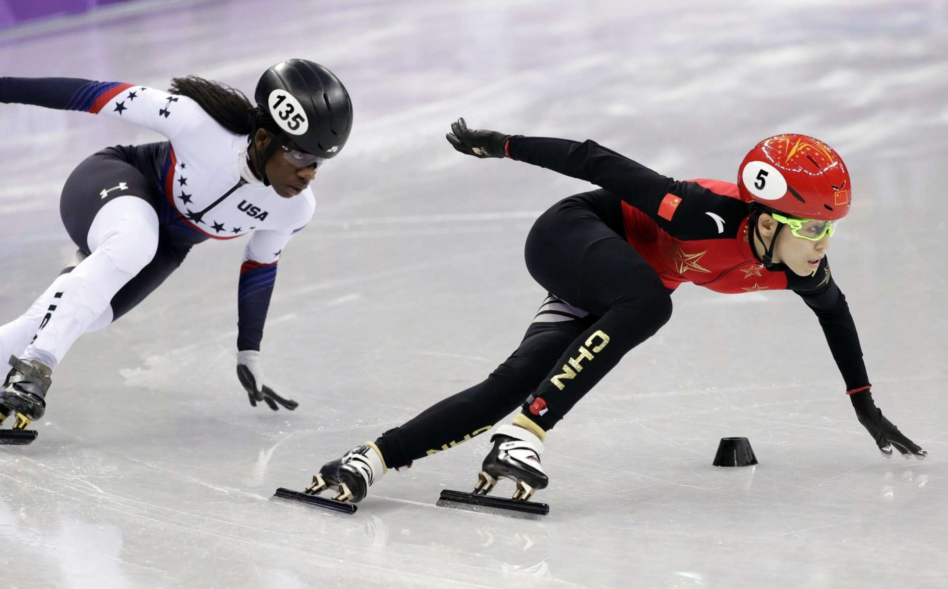 Kexin Fan of China leads Maame Biney of the United States in their ladies' 500 meters short-track speedskating heat in the Gangneung Ice Arena at the 2018 Winter Olympics in Gangneung, South Korea, Saturday, Feb. 10, 2018. (AP Photo/David J. Phillip)