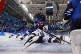 Mira Jalosuo, top, of Finland, checks Haley Skarupa, of the United States, during the preliminary round of the women's hockey game at the 2018 Winter Olympics in Gangneung, South Korea, Sunday, Feb. 11, 2018. (Grigory Dukor/Pool Photo via AP)
