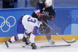 Garrett Roe (11), of the United States, checks Michal Kristof (13), of Slovakia, during the first period of the preliminary round of the men's hockey game at the 2018 Winter Olympics in Gangneung, South Korea, Friday, Feb. 16, 2018. (AP Photo/Frank Franklin II)