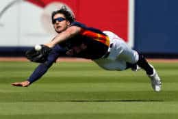 Houston Astros center fielder Jake Marisnick dives and catches a ball hit by Washington Nationals' Matt Adams to end the top of the first inning of an exhibition spring baseball game Friday.
 (AP Photo/Jeff Roberson)