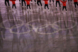 The shadows of performers are cast on the Olympic rings ahead of the closing ceremony of the 2018 Winter Olympics in Pyeongchang, South Korea, Sunday, Feb. 25, 2018. (AP Photo/Charlie Riedel)