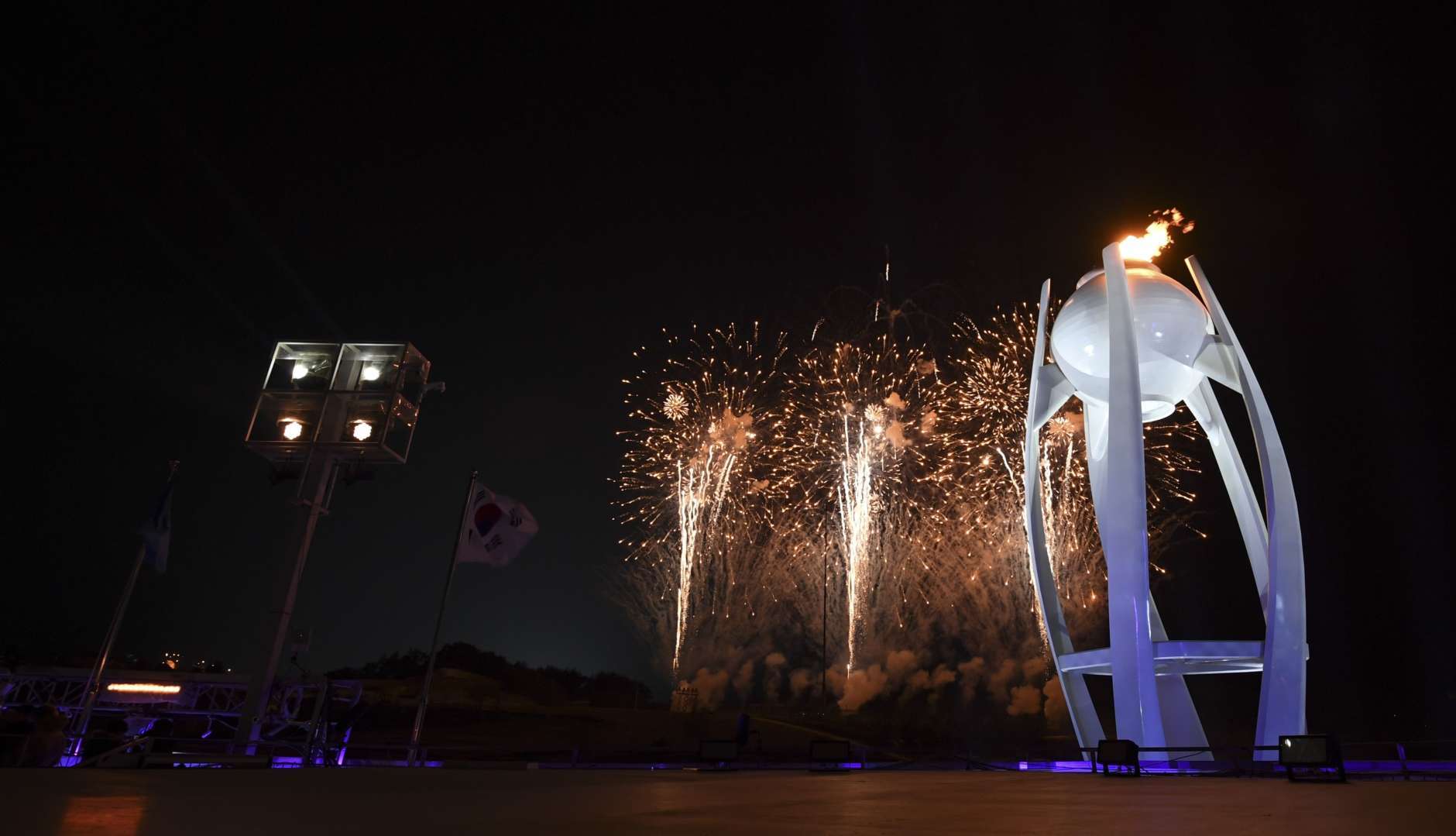 Fireworks explode behind the Olympic cauldron at the start of the closing ceremony of the 2018 Winter Olympics in Pyeongchang, South Korea, Sunday, Feb. 25, 2018. (Christof Stache/Pool Photo via AP)