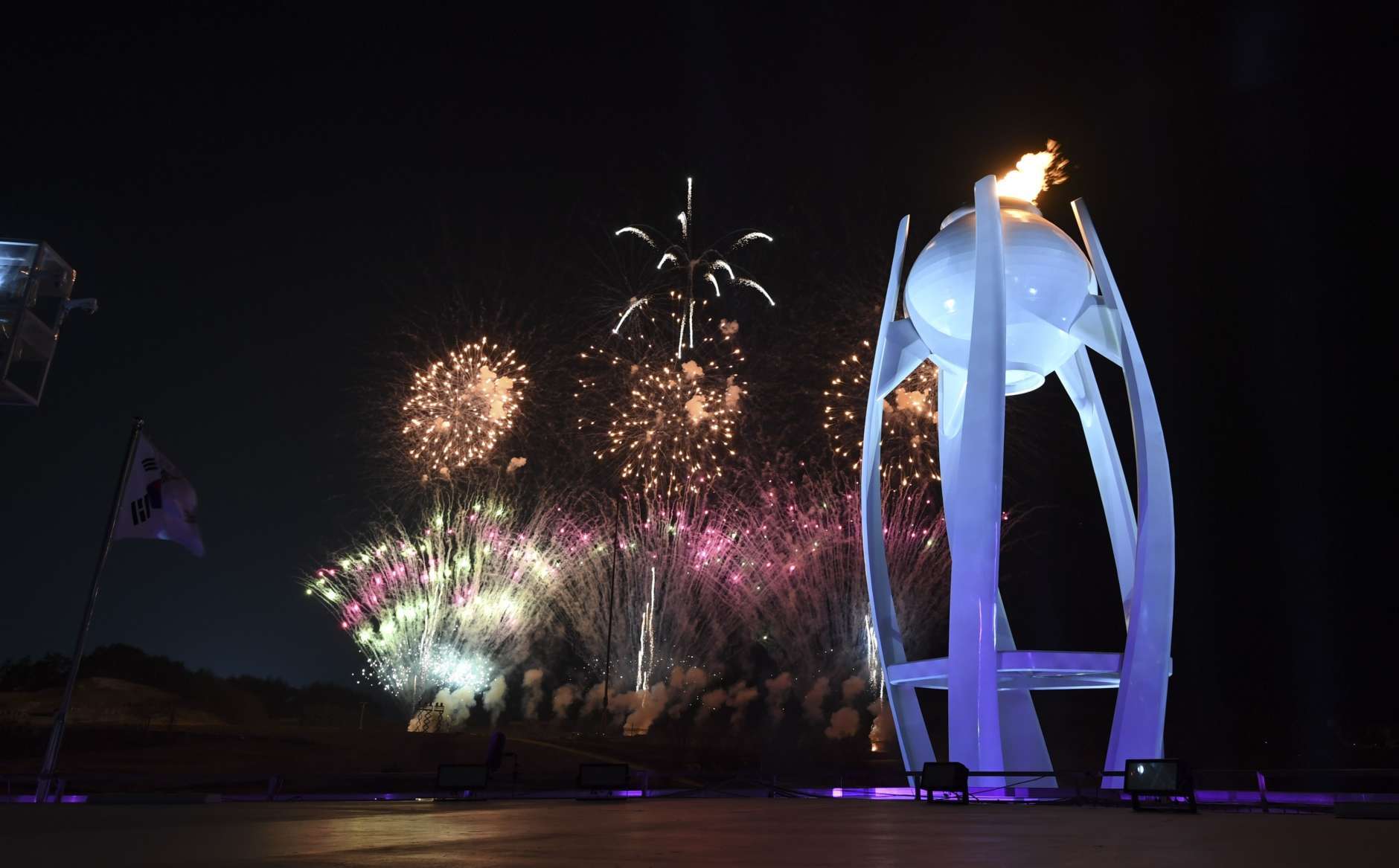Fireworks explode behind the Olympic cauldron at the start of the closing ceremony of the 2018 Winter Olympics in Pyeongchang, South Korea, Sunday, Feb. 25, 2018. (Christof Stache/Pool Photo via AP)