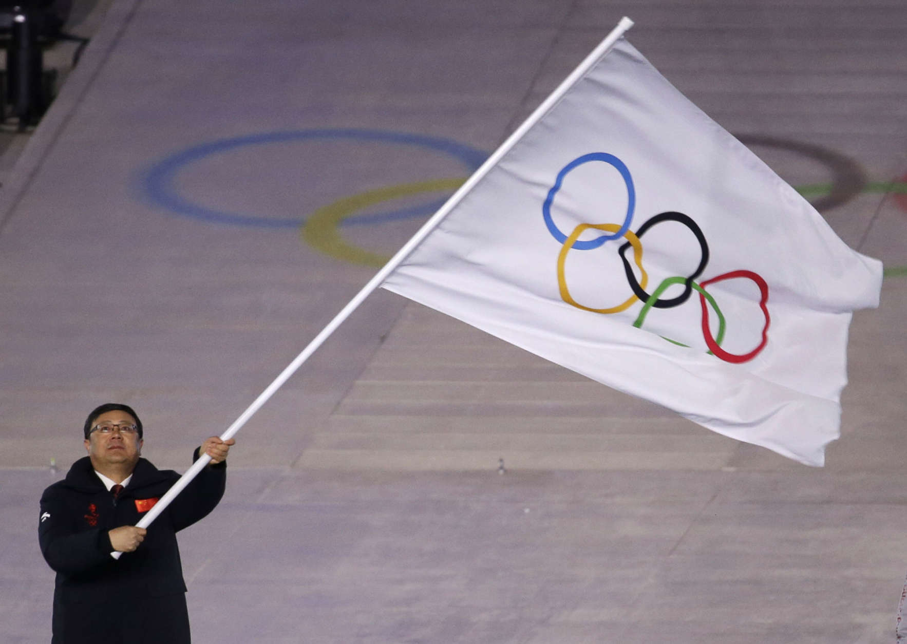Chen Jining mayor of Beijing waves the Olympic flag during the closing ceremony of the 2018 Winter Olympics in Pyeongchang, South Korea, Sunday, Feb. 25, 2018. (AP Photo/Natacha Pisarenko)
